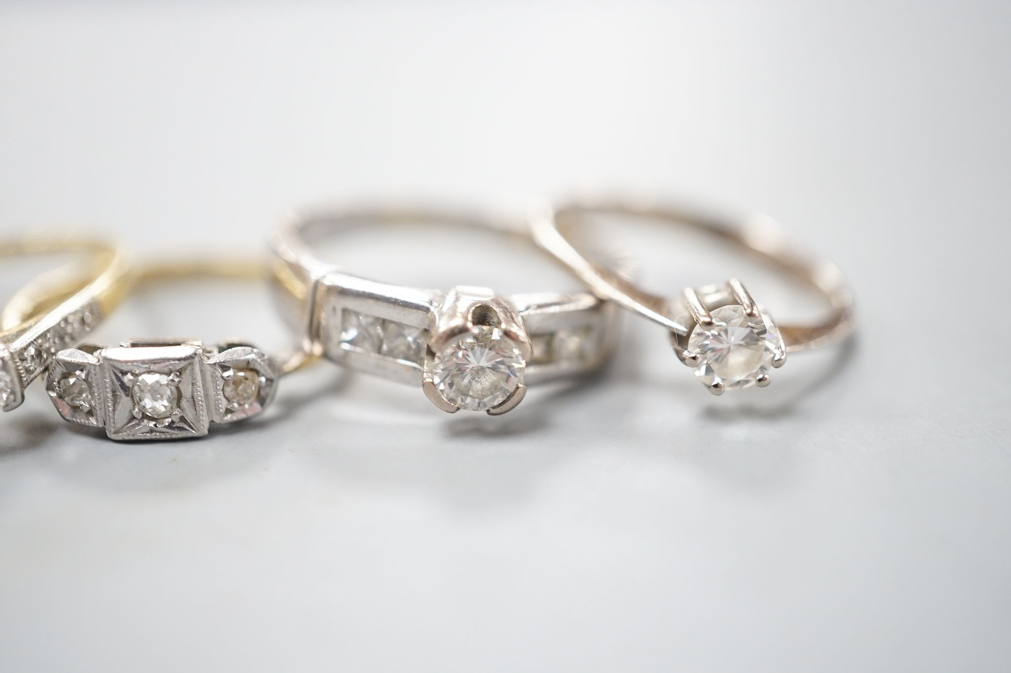 Four assorted diamond dress rings including two 18ct and two white metal, gross 10 grams